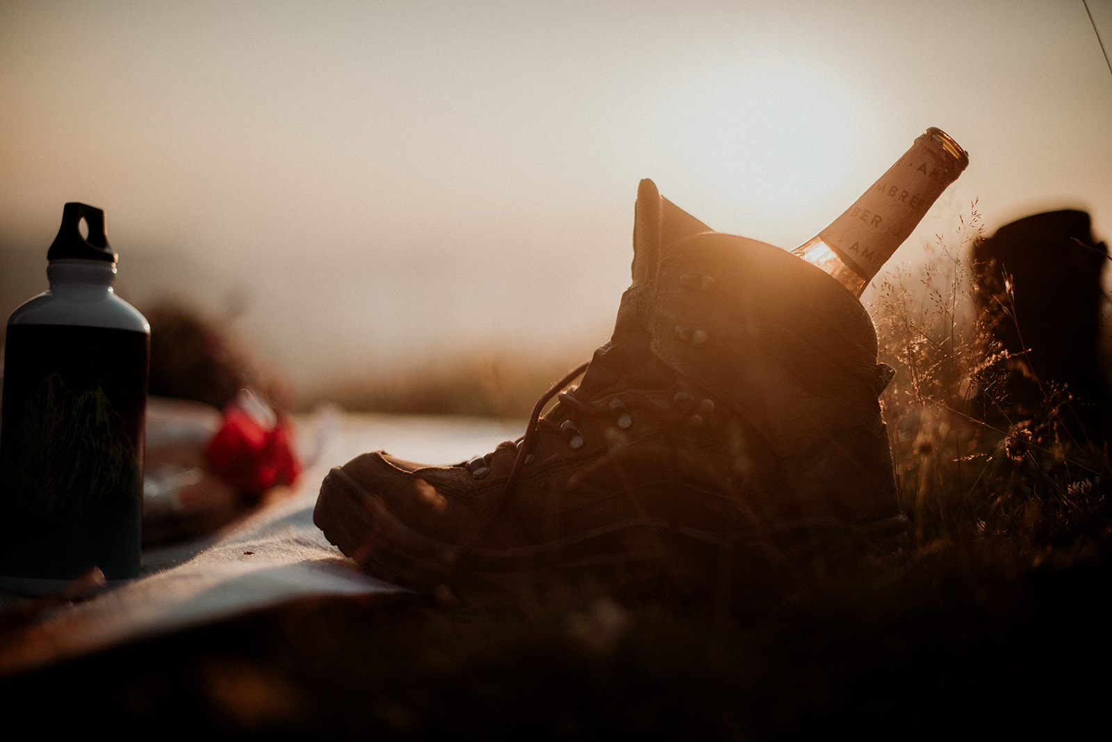 non-monogamous wedding ceremony - an open bottle of wine in a hiking boot at sunset in the Dolomites